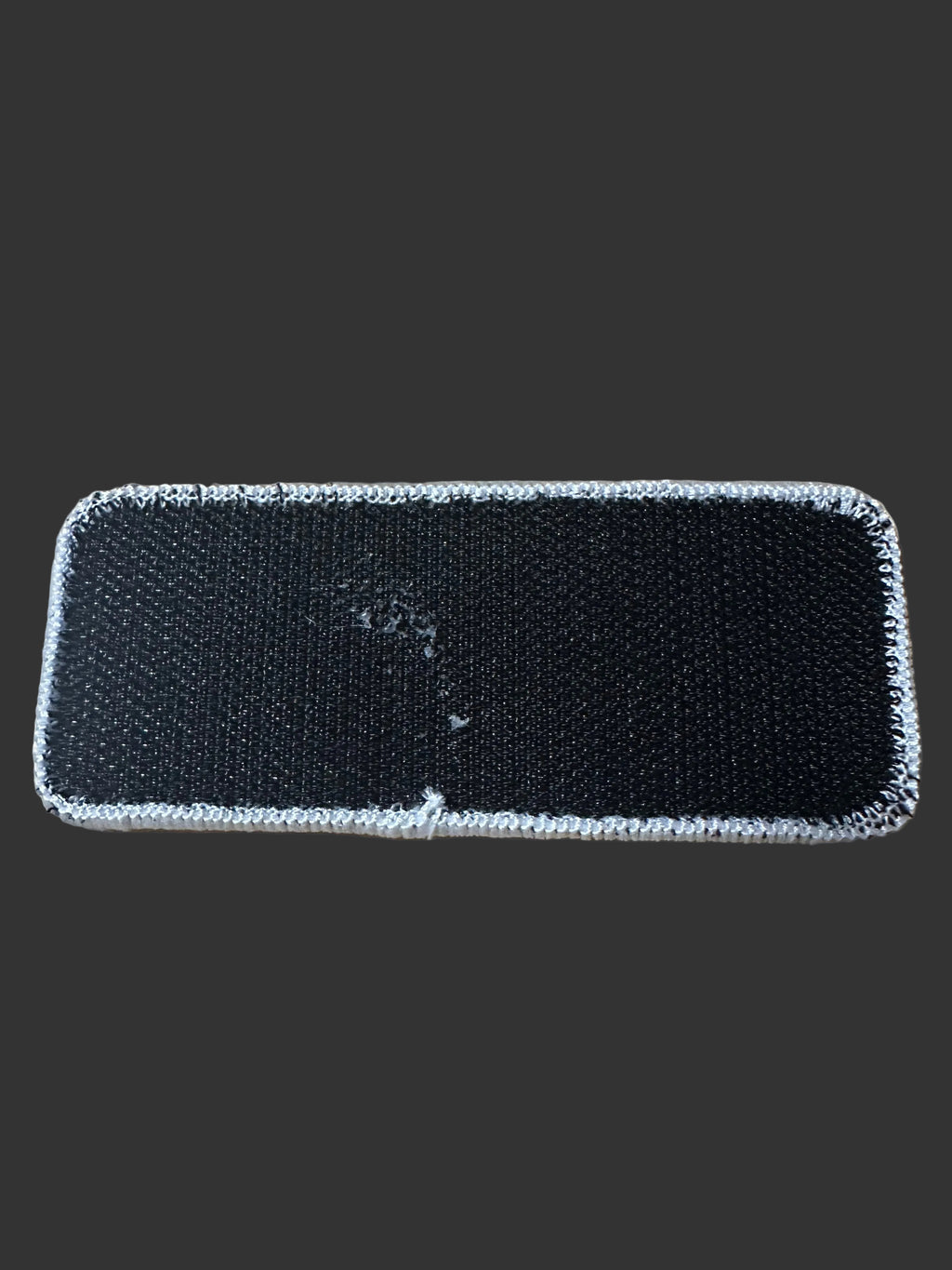Rear view of 405 Defense Apparel morale patch showing durable hook backing for attachment to tactical gear, range bags, backpacks, and jackets.