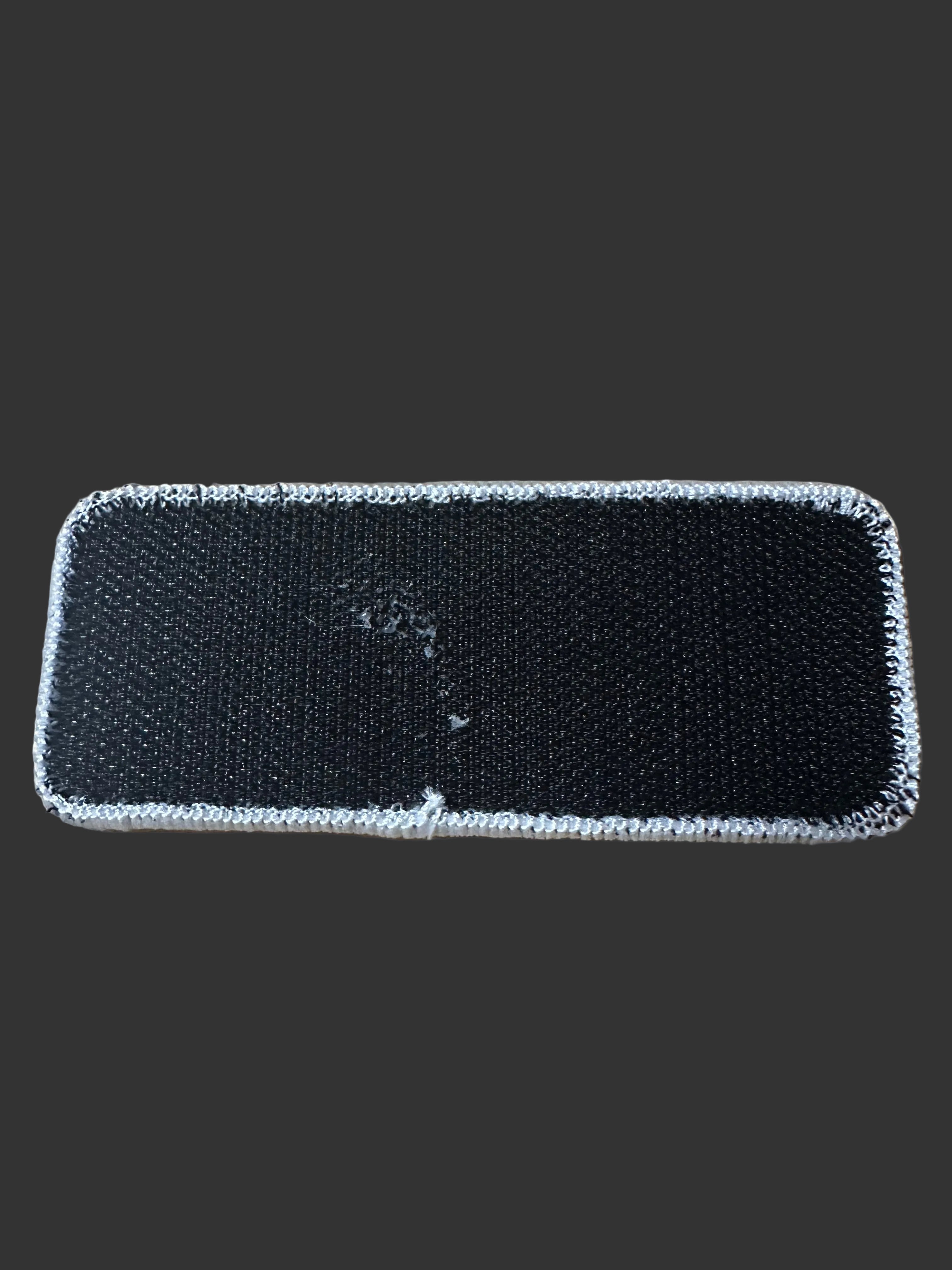 Rear view of 405 Defense Apparel morale patch showing durable hook backing for attachment to tactical gear, range bags, backpacks, and jackets.