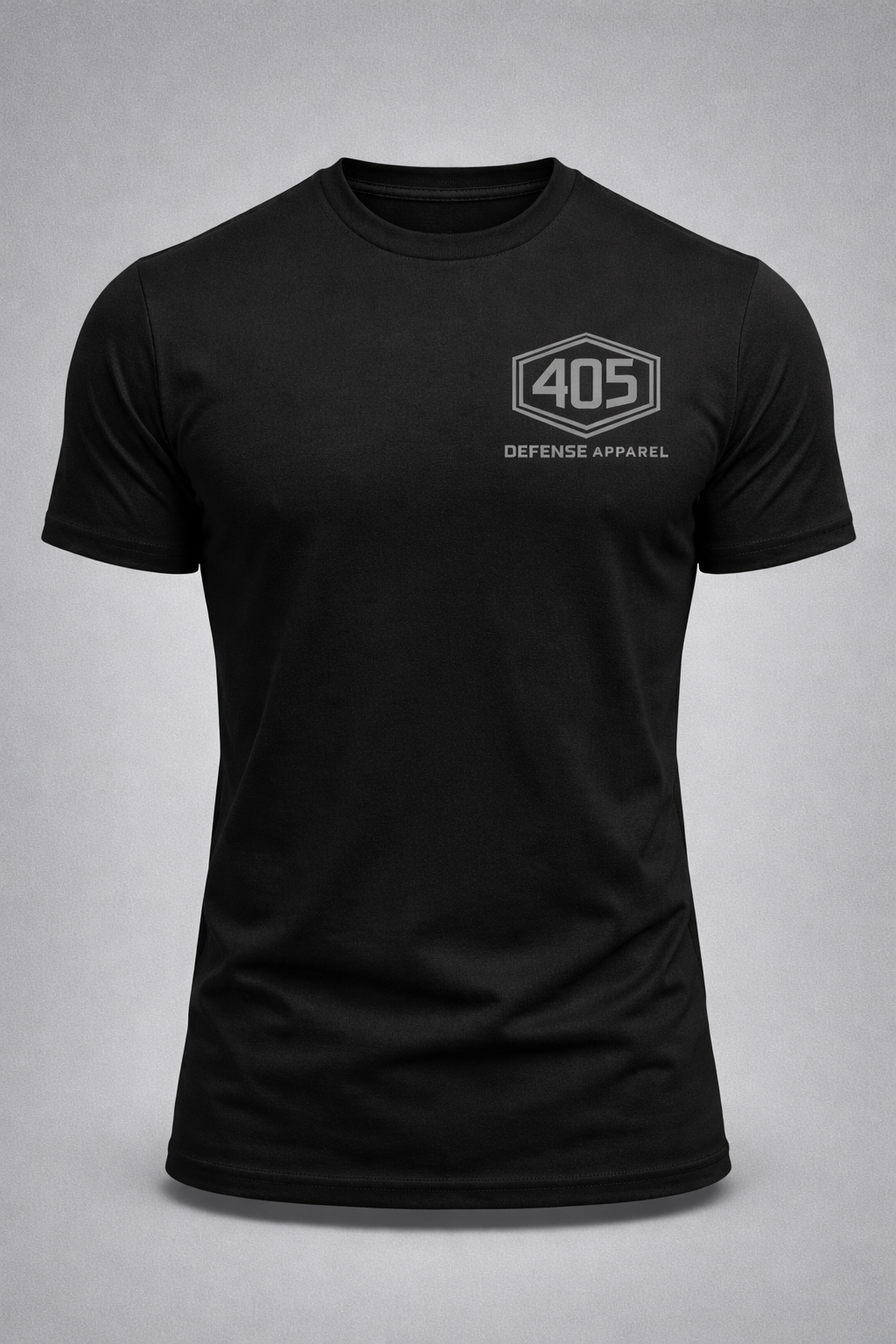 Black athletic-fit T-shirt, front-facing on a gray background, featuring a medium gray 405 Defense Apparel hex logo printed on the left chest.